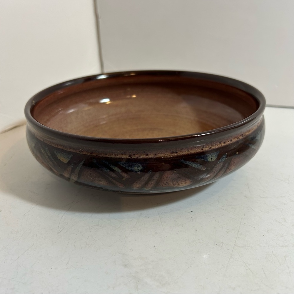 Handcrafted brown glazed pottery bowl with iridescentβ geometric design